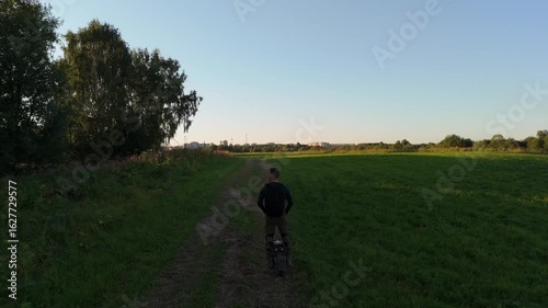 Man is riding a electric unicycle euc on a country road. People Ecological Electric Transportation Vehicle Monowheel