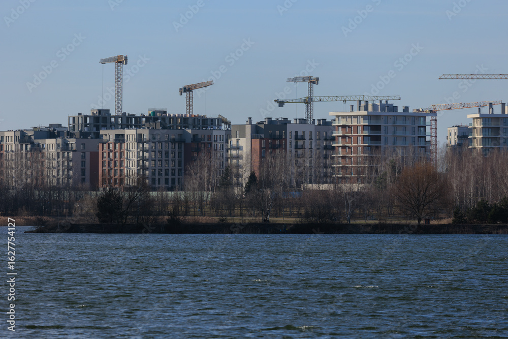 Naklejka premium Construction of buildings and high-rise cranes against the sky
