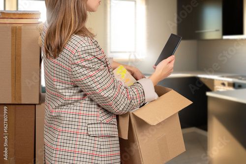 Woman with moving box. Girl...
