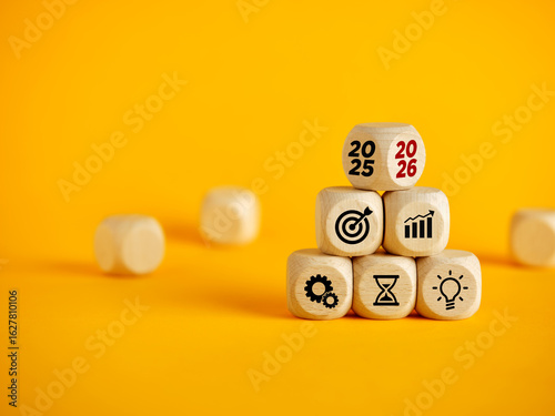 Business strategy planning for 2026 with icons on wooden blocks