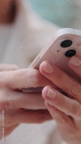 Vertical video, Woman Using Smartphone Outdoors. Close up of the phone