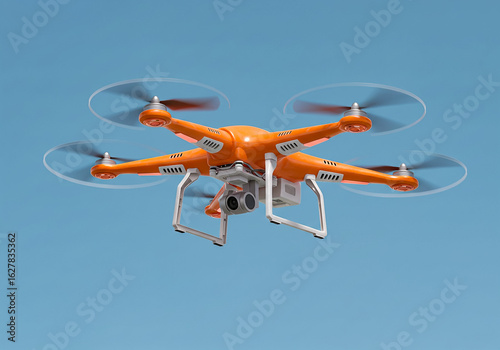 Orange drone with camera flying against a clear blue sky