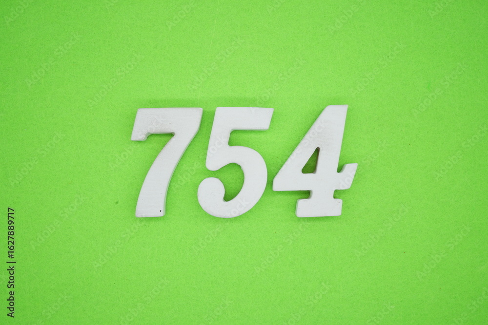 The numbers are made of white painted wood and placed on a green paper background. The numbers are made of white painted wood and placed on a green paper background.