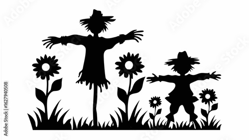 Silhouette of two scarecrows with hats standing among sunflowers and grass in a black and white image