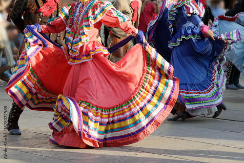 Dancers dancing and wearing one of the traditional folk costume from Mexico