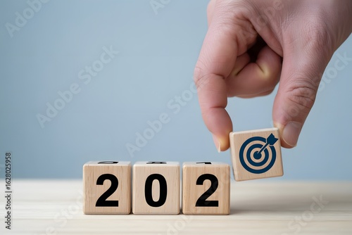 Wallpaper Mural Vision of Success in 2022: An individual's hand places a target-marked block next to 2022 blocks, depicting the realization of goals for the year. Torontodigital.ca