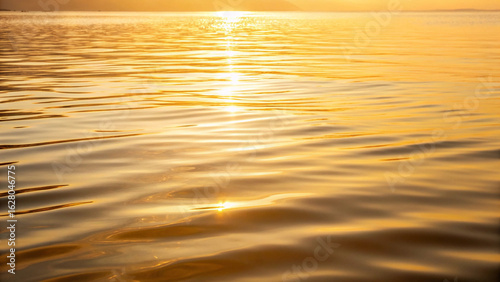 Golden hour sunlit water ripples reflecting sunlight calm tranquil scene nature