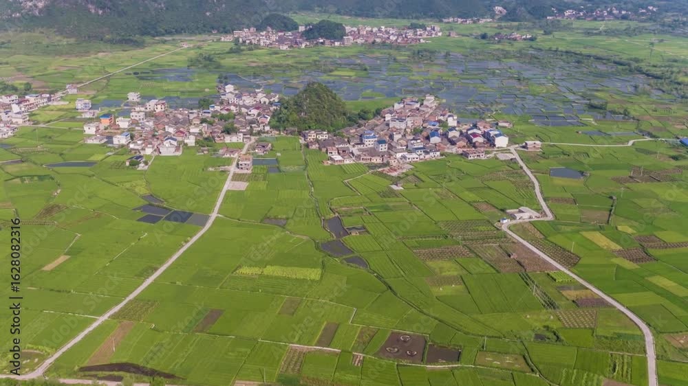 Aerial view of a village in the countryside with green fields and houses Aerial view of a village in the countryside with green fields and houses