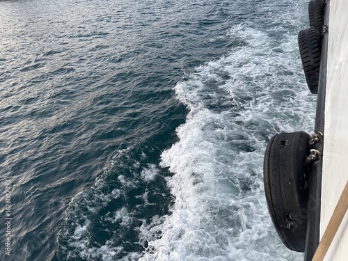 Fototapeta Naklejka Na Ścianę i Meble -  View of the Bosphorus from a ferry deck with tires on board in Istanbul, Turkey