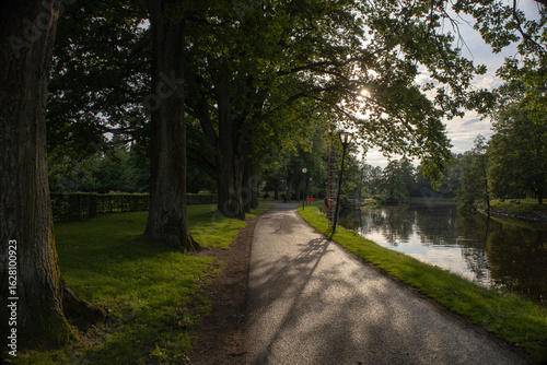 Fényképezés Scenic view of Orebro parks next to the flowing creek surrounded by natural gree