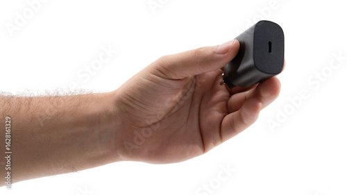 Bild auf Leinwand Hand holding a compact black charger accessory