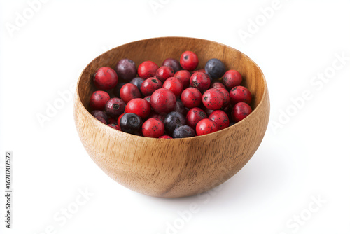 a wooden bowl filled with red and blue berries