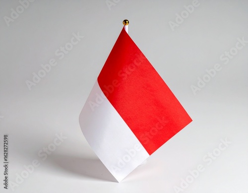 Wallpaper Mural A small Indonesian flag, red and white, stands against a plain white backdrop. Torontodigital.ca