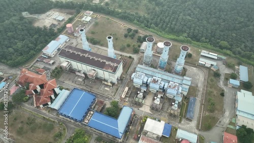 Aerial View of Power Plant with Cooling Towers and Industrial Equipment in July for Energy Generation