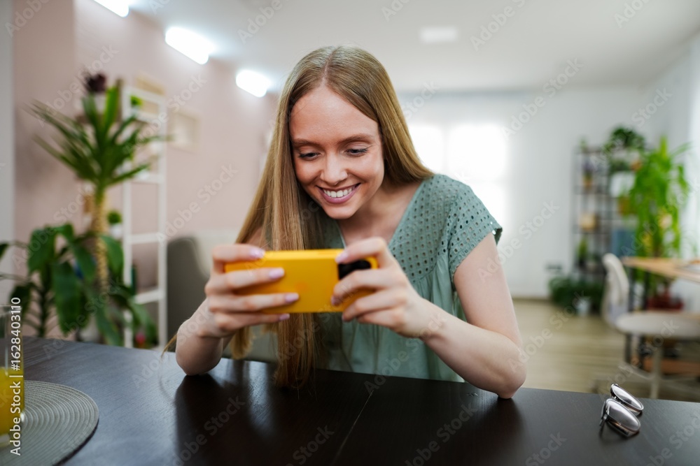 Engaging with a new mobile game in a cozy indoor setting Engaging with a new mobile game in a cozy indoor setting