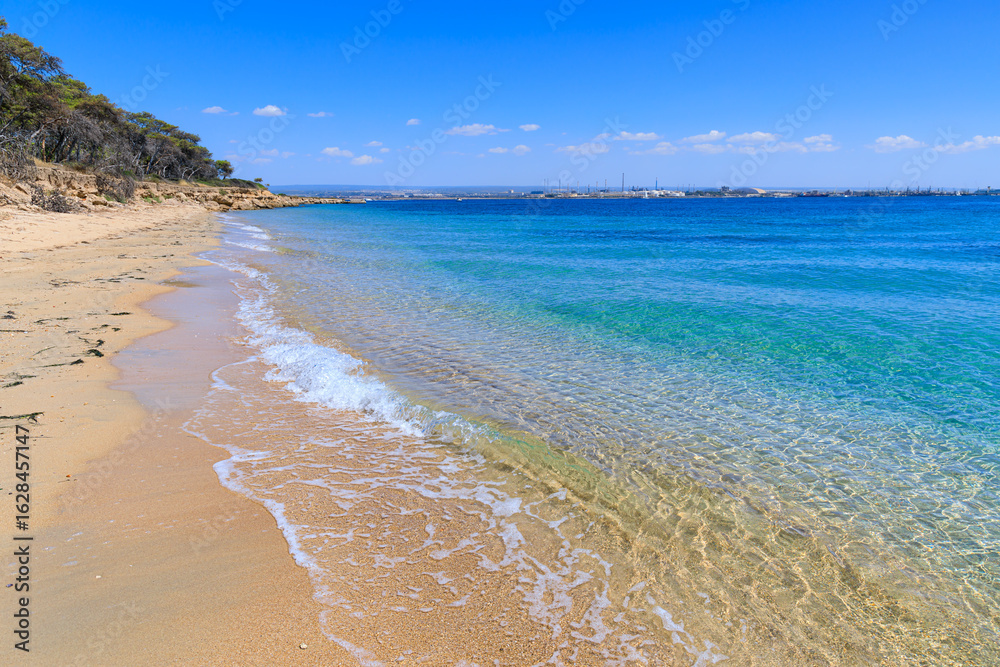 Obraz premium Cheradi Islands: view of San Pietro Island in Apulia, Italy. In the distance the skyline of the city of Taranto.