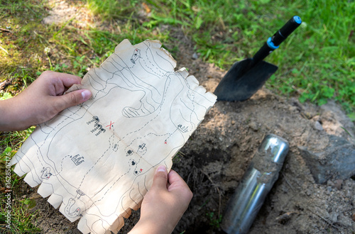 Fotografie Pirate treasure hunting map in a quest for kids