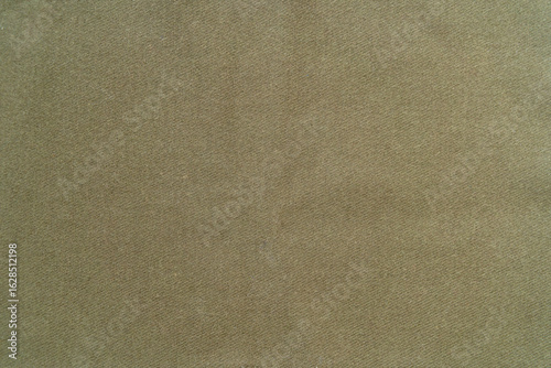 Beige cotton fabric.A photo of the texture of a green protective fabric.