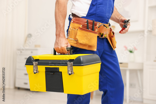 Quadro su tela Professional repairman with tool box indoors, closeup