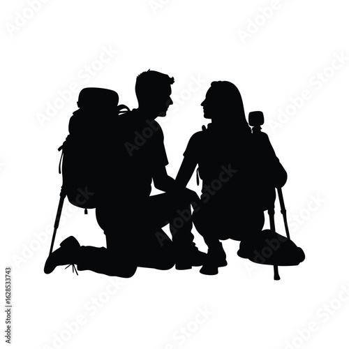 Silhouette of a hiking couple resting and facing each other during trek