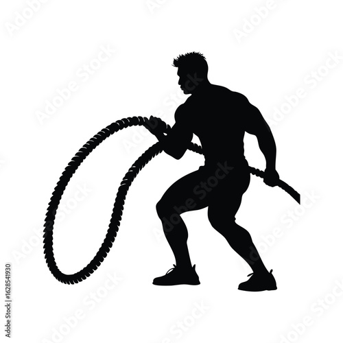 Silhouette of muscular man exercising with battle ropes in a gym