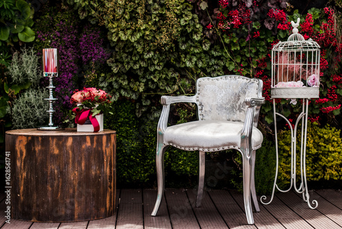 Εκτύπωση καμβά Silver chair, flowers, and birdcage creating a romantic wedding atmosphere