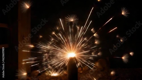 Tiny sparks flying from old lantern ignition in the dark  