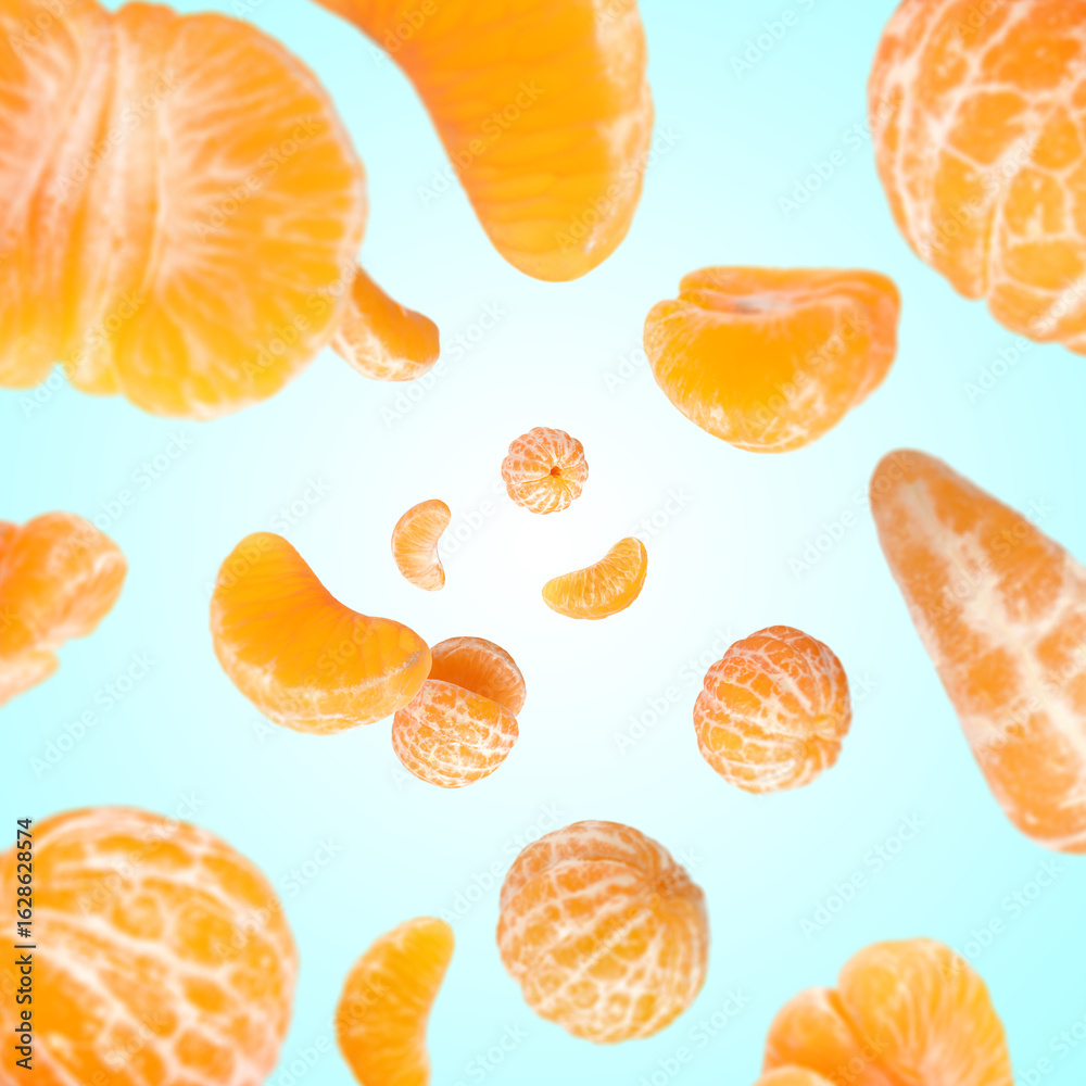 Fototapeta premium Sweet tangerines whirling in air against light blue gradient background