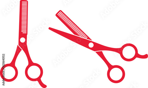 Two bright red professional hair cutting shears one open one closed isolated on white background