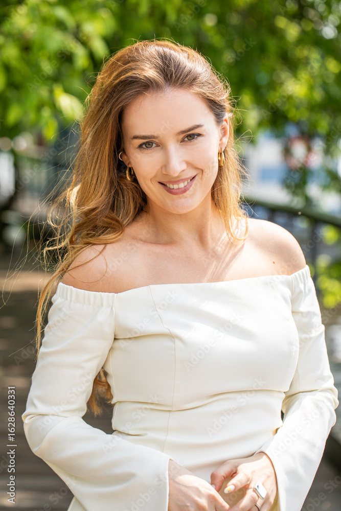Young beautiful model in a white short dress with long sleeves Young beautiful model in a white short dress with long sleeves