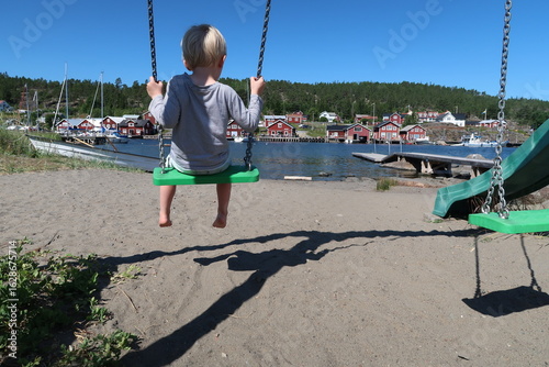 Young boy on a swing on the beach