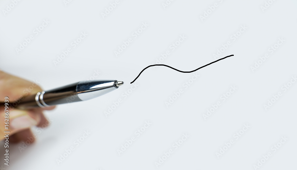 Fototapeta premium Pen in hand with a drawn line