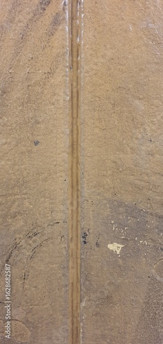 Close-up textures of industrial brown painted riveted metal surfaces with bolts, scratches, and weathered paint, ideal for backgrounds and design elements