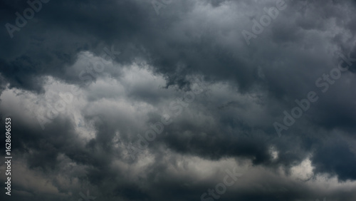 cloudy sky. photo dark thick clouds. background dramatic storm cloudscape. format 16x9
