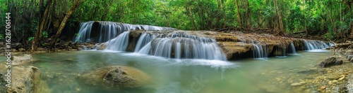 The deep forest of Thailand contains a picturesque waterfall that is panoramic and beautiful