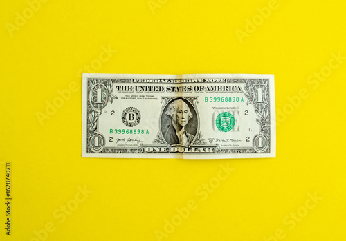 Dollar on a yellow background, background with copy space.