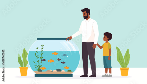 Loving father and his young son observing colorful pet fish in a large round aquarium at home, a moment of family bonding.