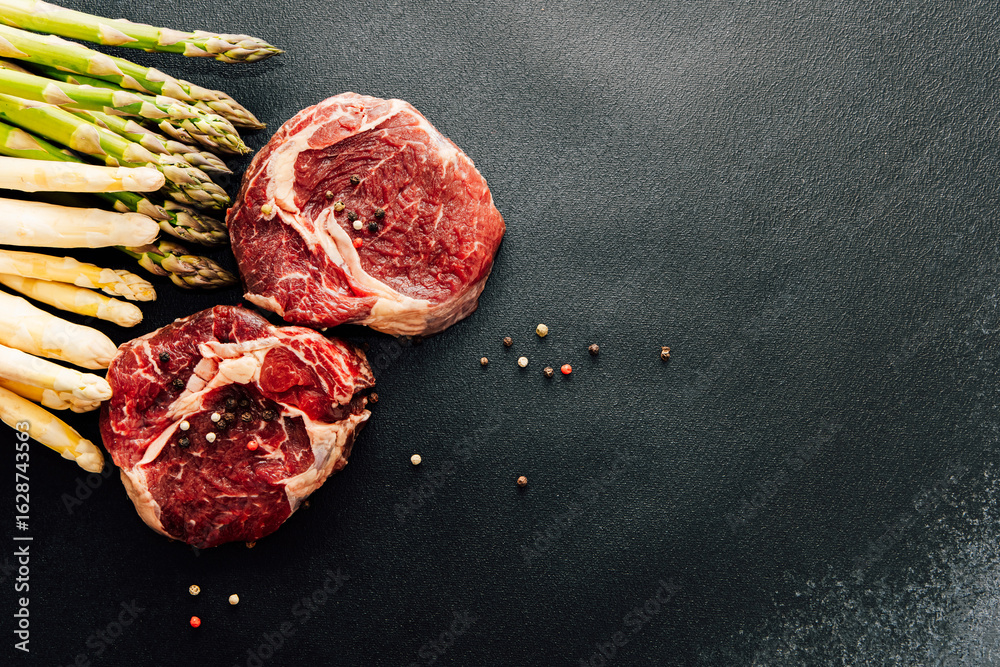 Fototapeta premium Fresh cut beef and asparagus prepared for a gourmet meal in a kitchen setting