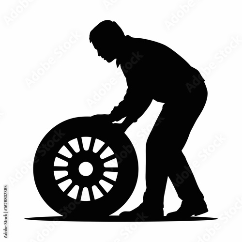 Silhouette of a Man Changing a Tire