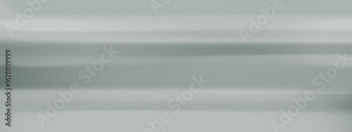 Eco-friendly abstract backdrop in muted gray green shades with natural grainy texture and soft horizontal flow