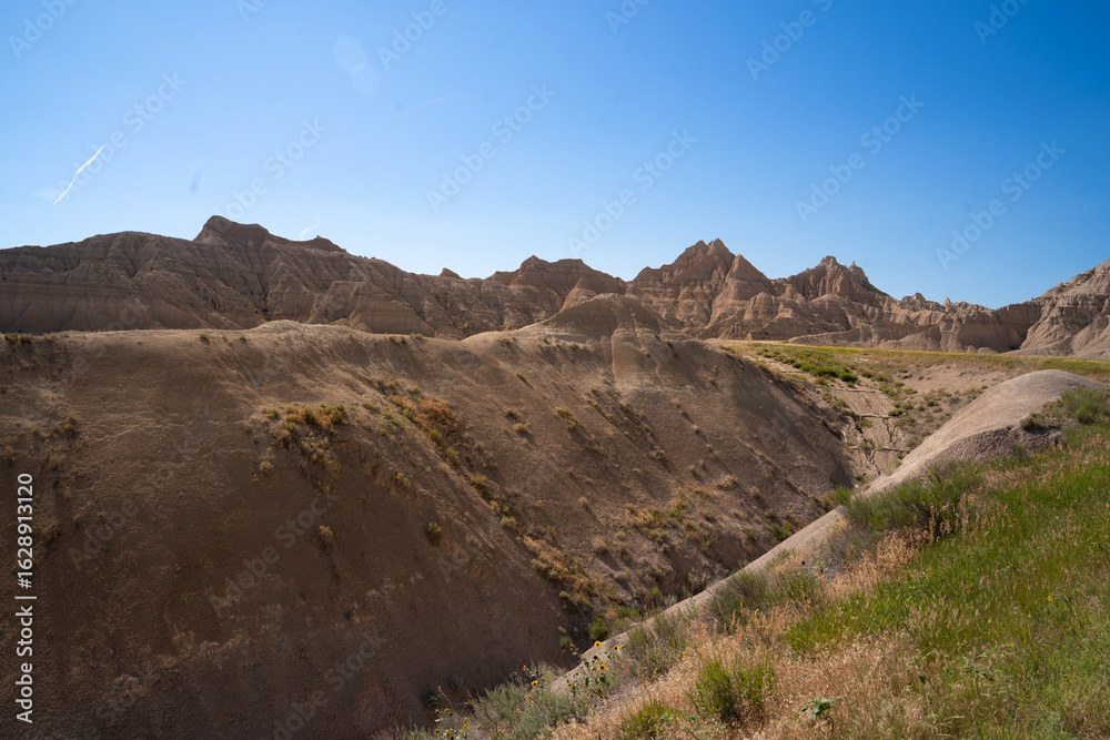 Open grassland with distant Badlands rock formations. Open grassland with distant Badlands rock formations.