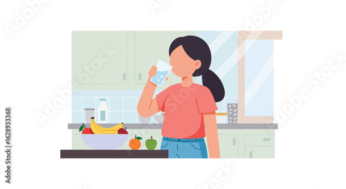 Woman drinking water in kitchen with fruit bowl and light blue jeans.