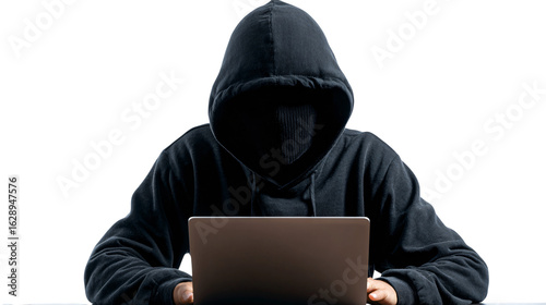 Mysterious hacker typing rapidly on laptop in the shadows
