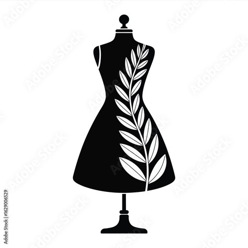 Elegant black dress with a botanical leaf design on a mannequin