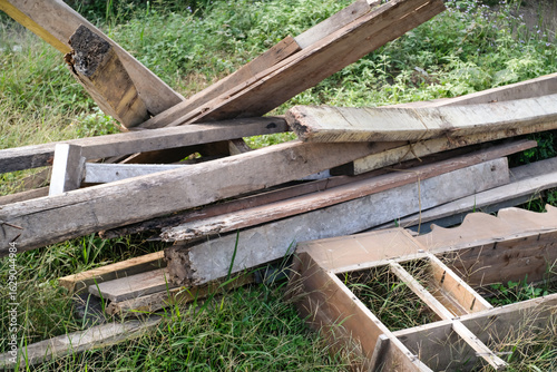 Картината върху платно A close-up shot of the remains of a house pillar and roof in the grassy yard