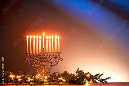 Menorah with lit candles and festive garland