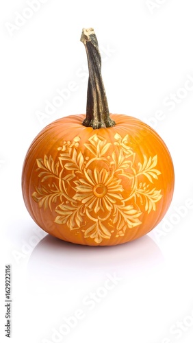Intricate carved design adorns a small, orange pumpkin against a white background