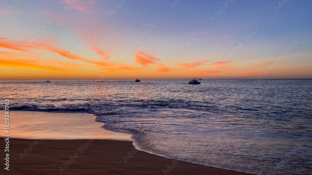 Obraz premium Fishing Boats Going out for the Day at Sunrise in Cabo San Lucas Mexico