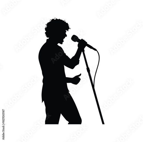 Silhouette of a male singer passionately performing with a microphone stand