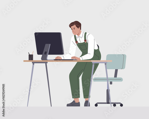 A focused man is seated at a desk using a computer in a creative workspace, symbolizing productivity and the modern work environment infused with style and organization.